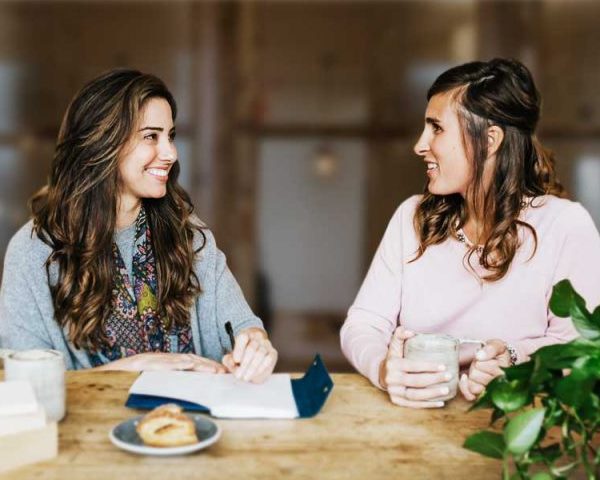Counselors Jennifer and Reagan are sitting at a table smiling. They are excited to begin academic coaching in Southlake, TX. Online Coaching with The Well House can help you kids succeed in school. Call now!