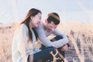 Mixed couples sitting in field laughing together. You're not married yet, but you've considered it. How can couples counseling near Southlake, TX help? Learn from a skilled couples therapist who can help you connect. Begin marriage counseling and couples therapy in Southlake, TX today or via online therapy in Texas. 