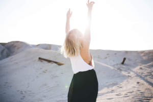 Woman reaching up arms up to bright sun. If you're struggling with feeling stuck EMDR therapy in Texas may help. Become unstuck and heal. Work with a skilled online therapist who gets it and provides emdr therapy near me "southlake 76092"