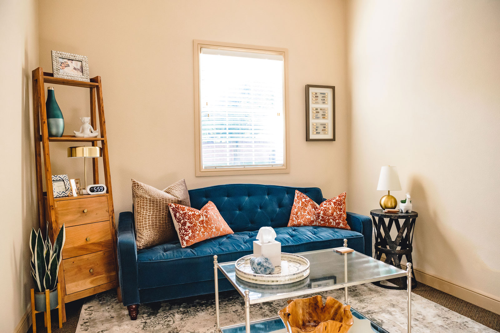 A modern living room showcasing a blue couch paired with a coffee table