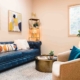 A living room featuring a blue leather couch and a matching blue chair, creating a cohesive and stylish seating area